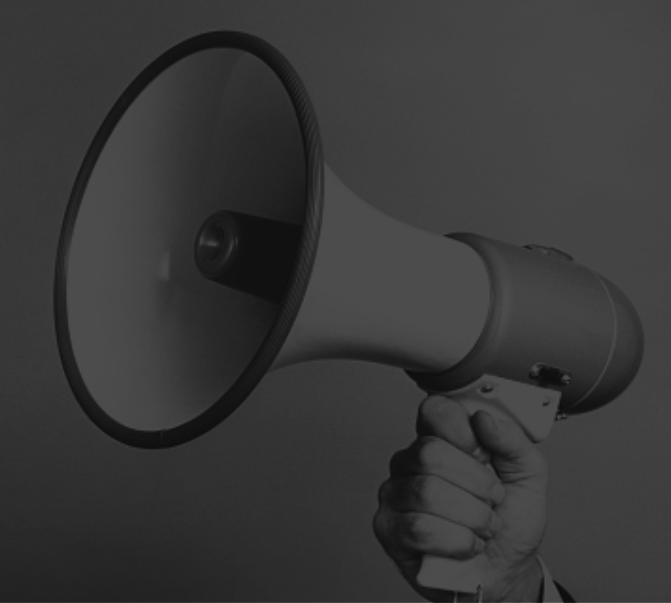 Hand holding a megaphone representing bold brand messaging by The Blondes creative agency